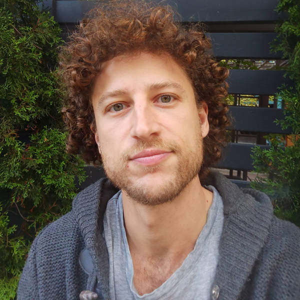 A friendly, professional headshot of Daniel Cooper, a Registered Psychotherapist (Qualifying) in Toronto.